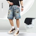 Blue men's denim shorts with ripped knees and graffiti图案, featuring a straight leg and zipper fly.