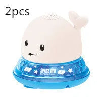 Electric whale bath toy with automatic water spray and flashing lights on a base