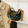 Women's woven straw crossbody bag showing internal phone compartment and file pocket in milky white colour