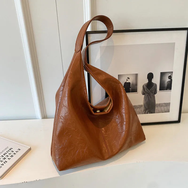 Soft PU leather casual shoulder bag with an adjustable strap, shown in a choice of colours.