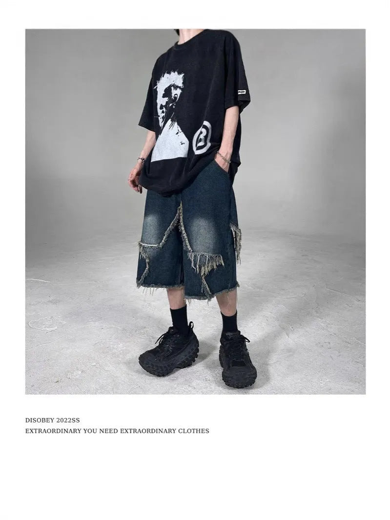 Blue cotton denim shorts for men with frayed hem detailing and five-pointed star patch, loose fit retro style