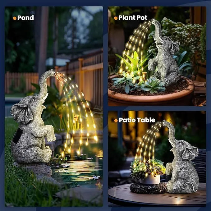 Grey resin elephant garden statue with white LED string lights wrapped around its body.