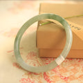 Green jade geometric bracelet with waxy finish, 10mm diameter, Chinese-style design