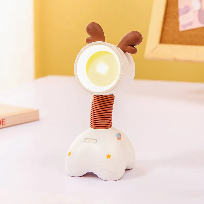 DIY cartoon character small desk night lamp with magnetic adjustable base on a wooden table.
