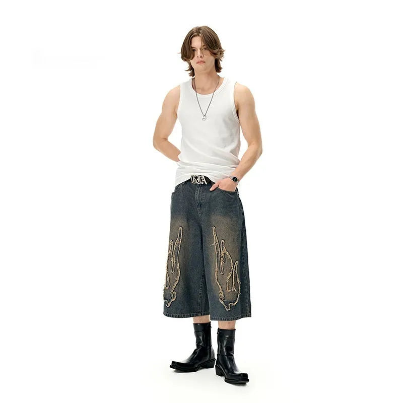 Men's black denim shorts with flame embroidery patch, cropped length and straight fit streetwear style
