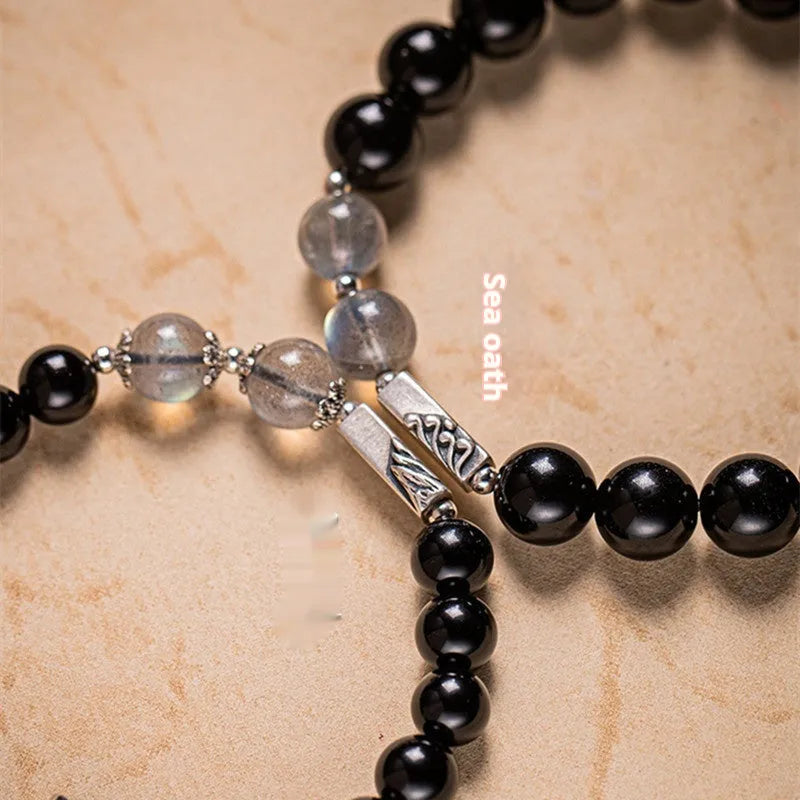 Obsidian Buddha beads couple bracelet set showing 10mm men's and 8mm women's Tibetan style bracelets