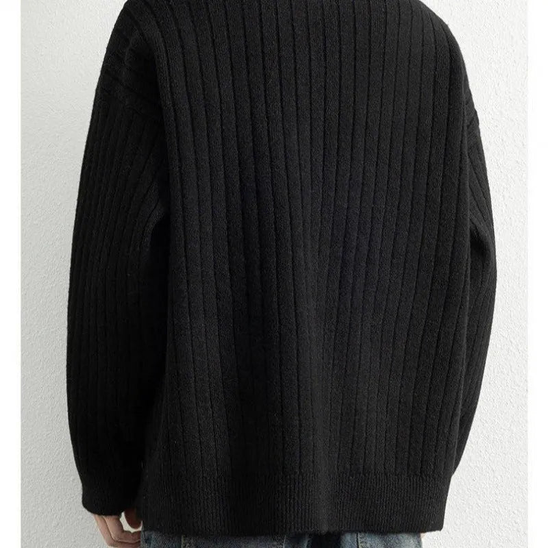 Men's grey half-zip loose knitted pullover sweater with textured fabric on a solid colour background.