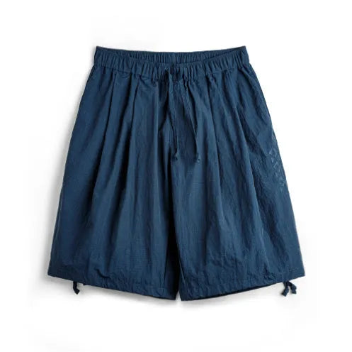Men's loose Prussian Blue nylon summer shorts showing fifth pants length and non-elastic waistband.