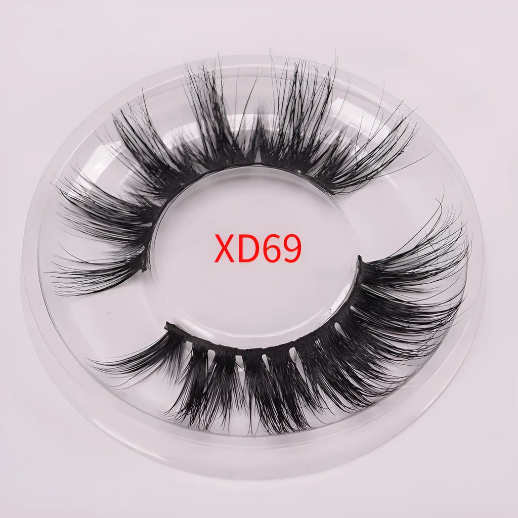 Handmade 5D mink false eyelashes set with storage case and double-headed brush on a clean background.