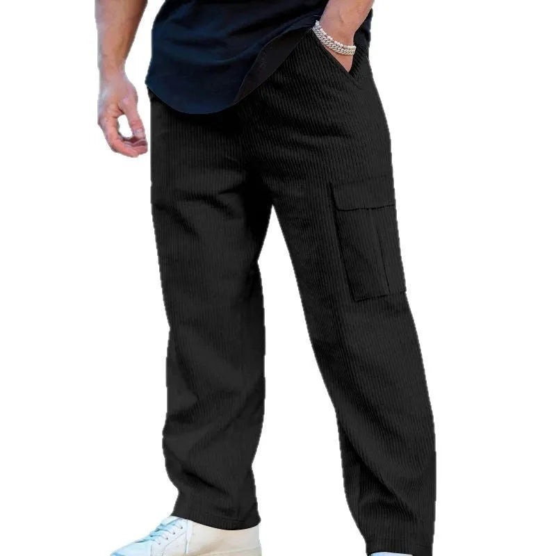 Men's navy blue corduroy cargo trousers with wide-leg design and drawstring waist laid flat.