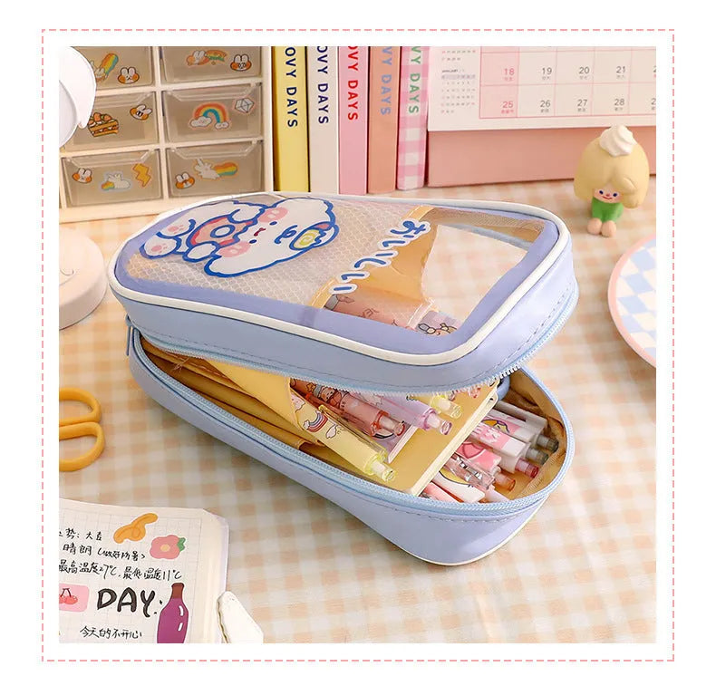 Transparent PVC pencil case with cartoon design showing large capacity interior and zipper closure