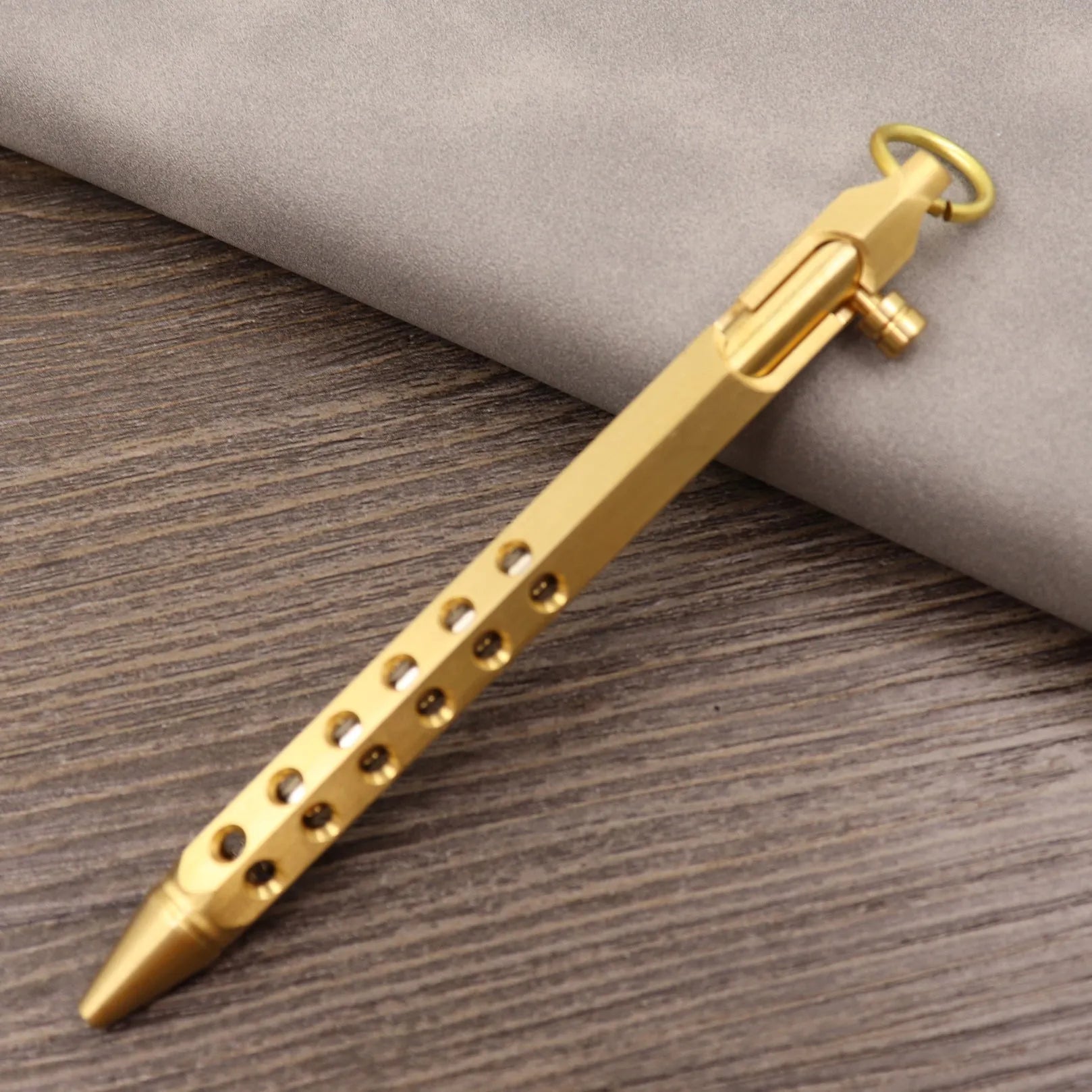 Brass tactical pen with bolt-action cylinder press mechanism in retro design