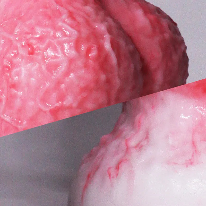 Pink platinum silicone penis-shaped masturbation toy on a neutral background