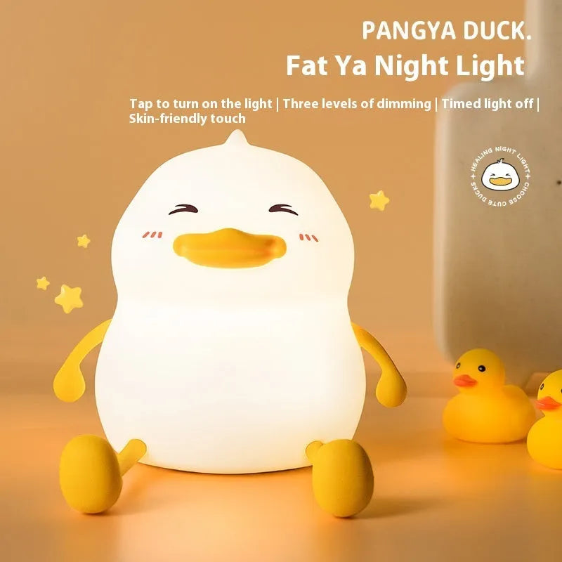 Chubby silicone night light with phone holder slot, showing touch controls and soft LED glow
