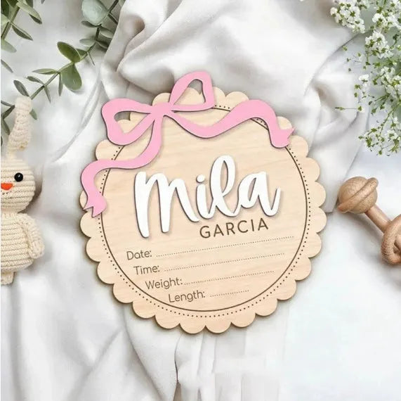 Customisable square wooden baby room ornament with a name, shown in two size options.