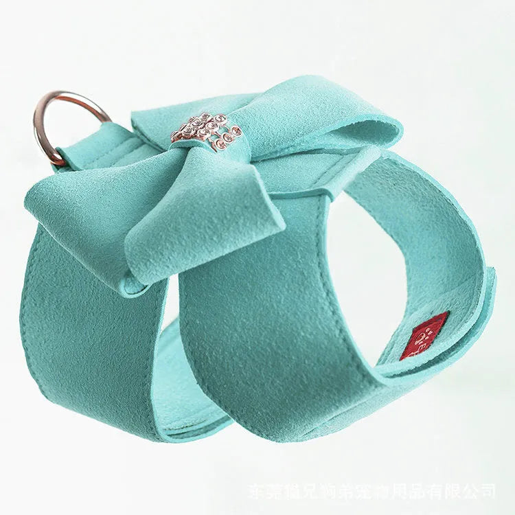 Dog harness with bowknot design in microfiber material showing pink, blue and orange colour options