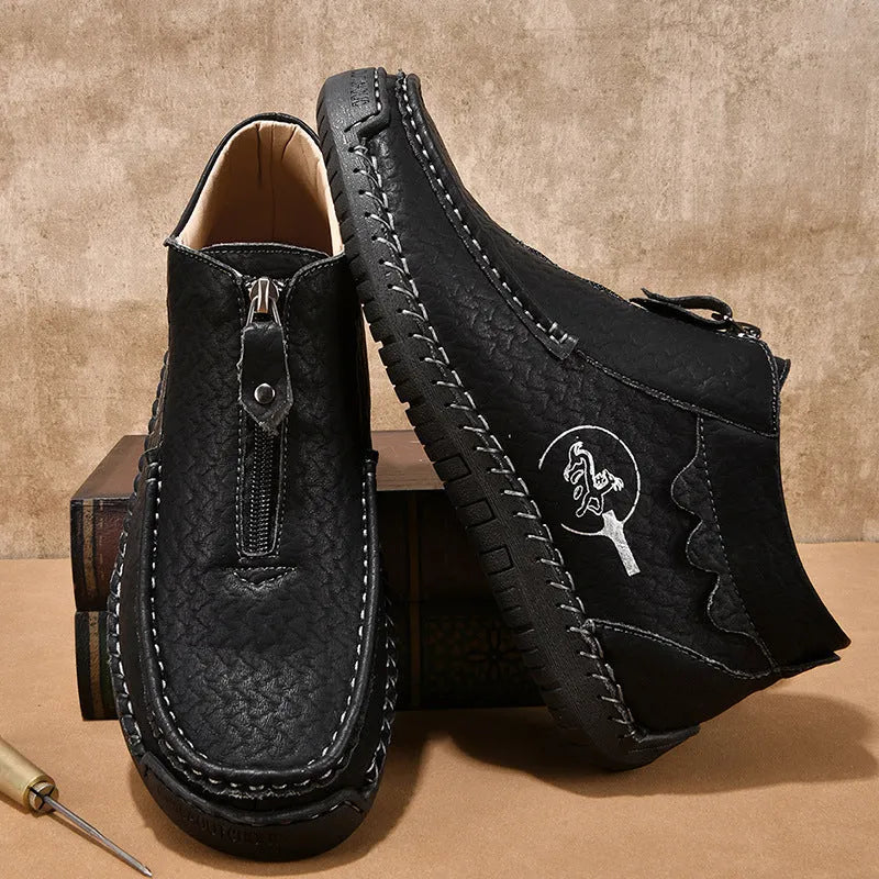 Men's black slip-on leather loafers with a round toe and visible stitching on a sewn rubber sole.