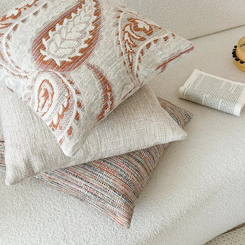 American-style paisley jacquard sofa backrest cushion in Amber colour on a grey sofa.