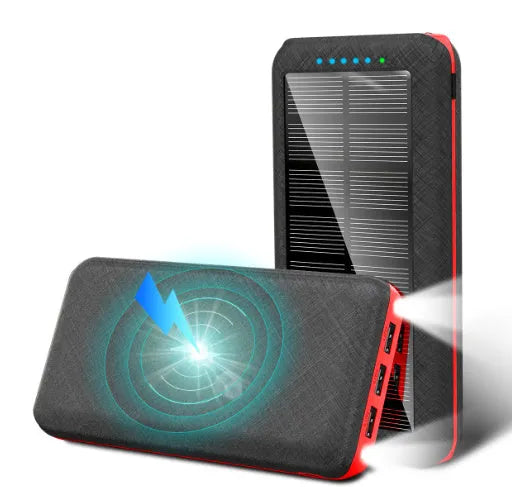 Black portable solar power bank with wireless charging pad and three USB ports on a wooden surface.