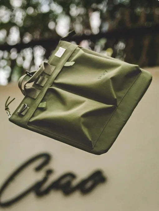 Medium nylon canvas messenger bag in military green with crossbody strap and laptop compartment
