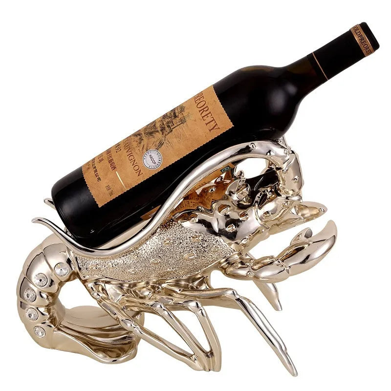 Lobster-shaped wine rack ornament in rose gold or silver resin finish on a table.
