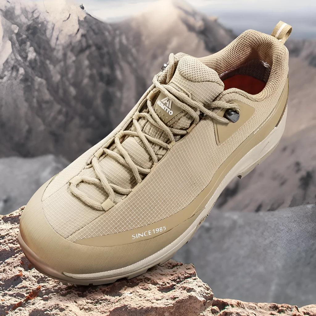 Men's low-top hiking boots in black with leather mesh upper and lace-up front.