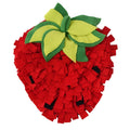 Red and green strawberry-shaped pet slow feeder snuffle mat on a floor