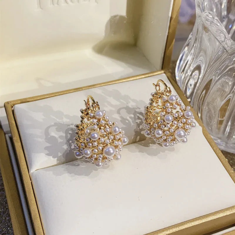 Gold-coloured copper flower basket earrings for women with small bead detailing and pearl inlay.