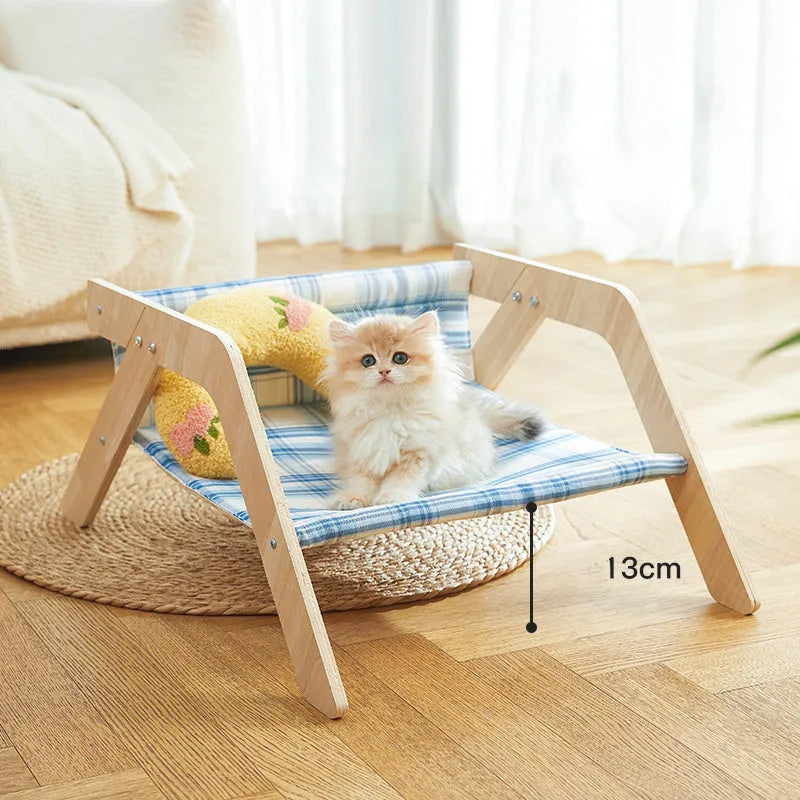 Wooden frame cat hammock bed with soft blue cloth on a wooden beach chair structure
