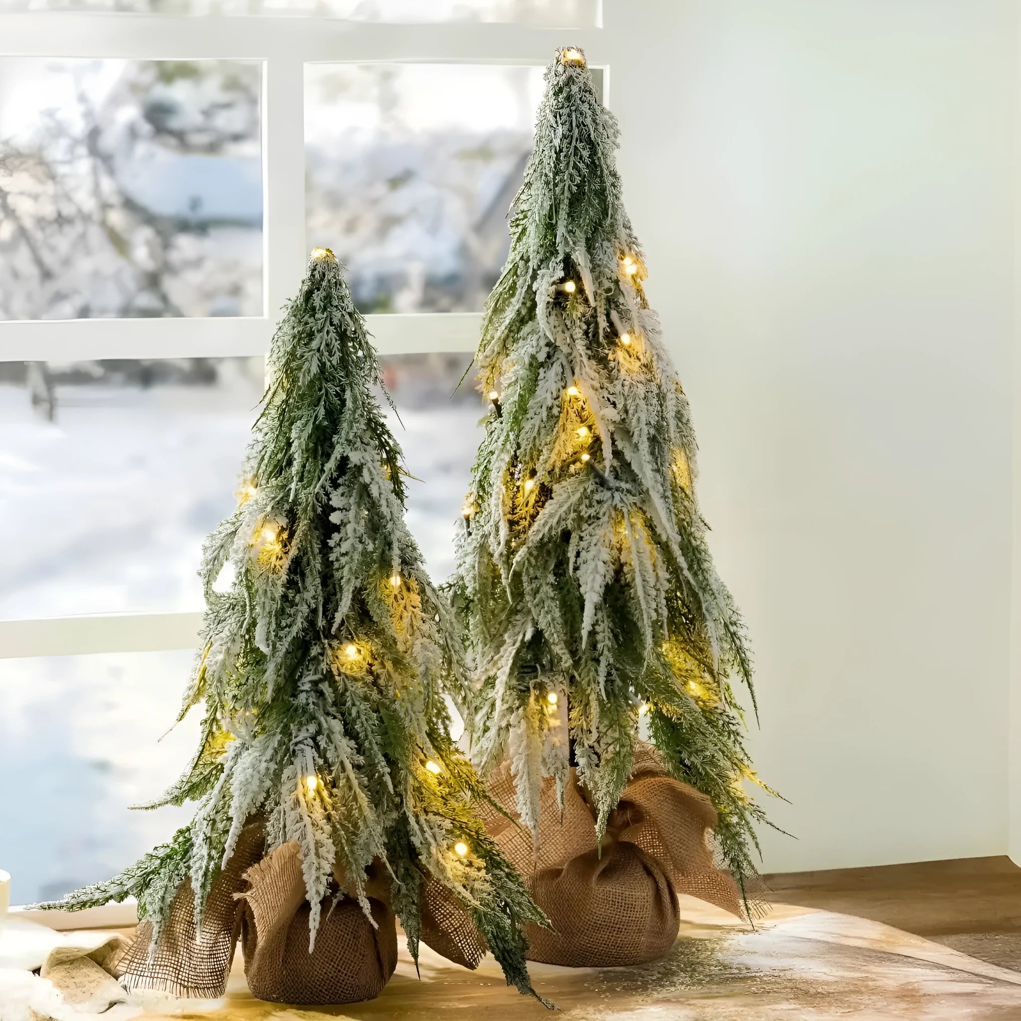 Small 24-inch desktop artificial Christmas tree with white snow sprayer effect and integrated coloured lights