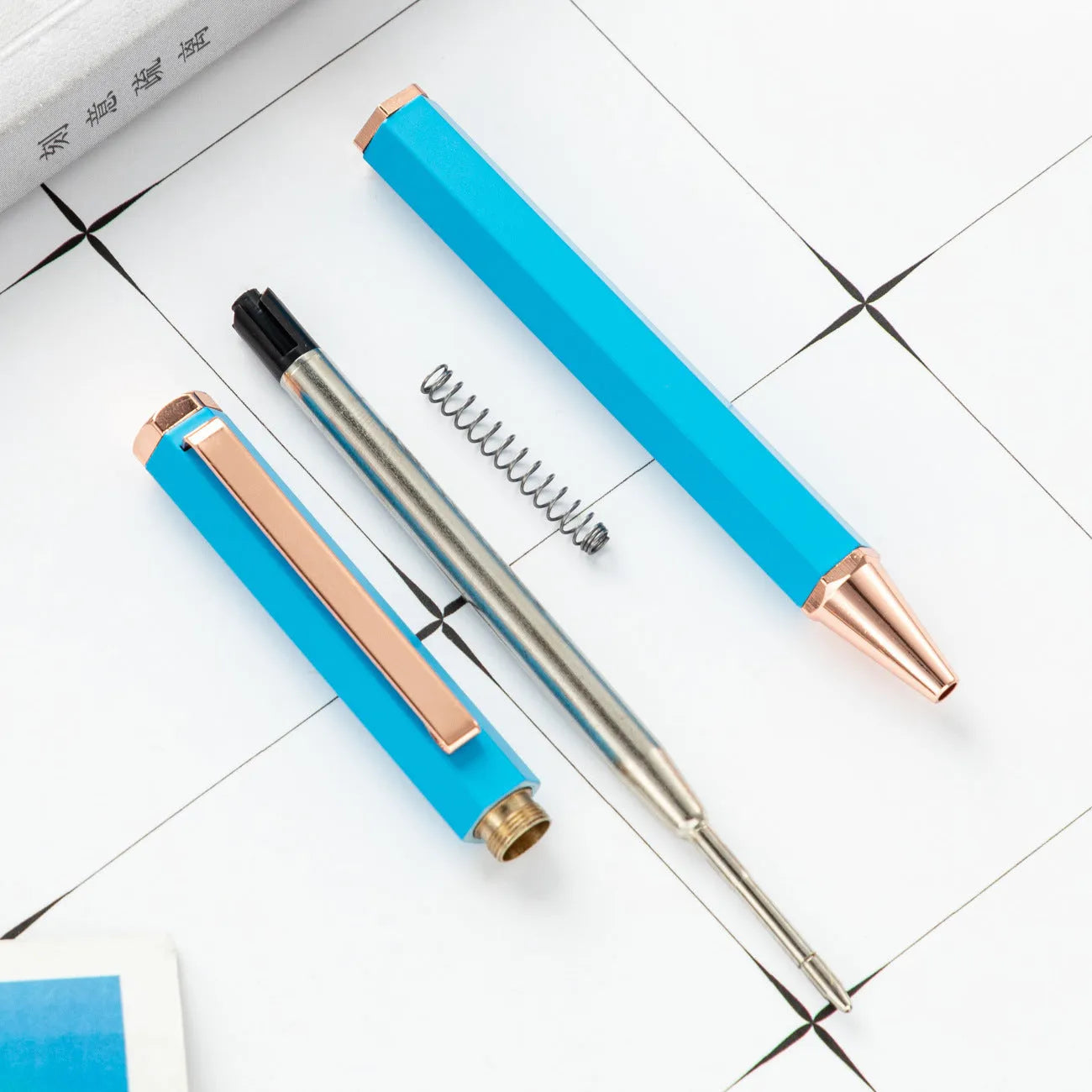 Metal ballpoint pen with six-angle rod body and bullet tip in black colour on white background