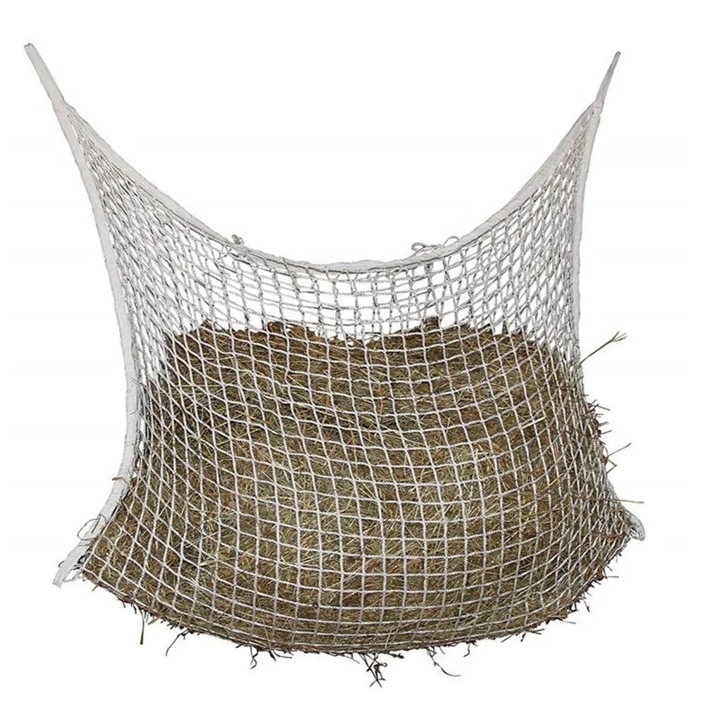 Black woven PE rope mesh feeding bag for horses hanging on a fence