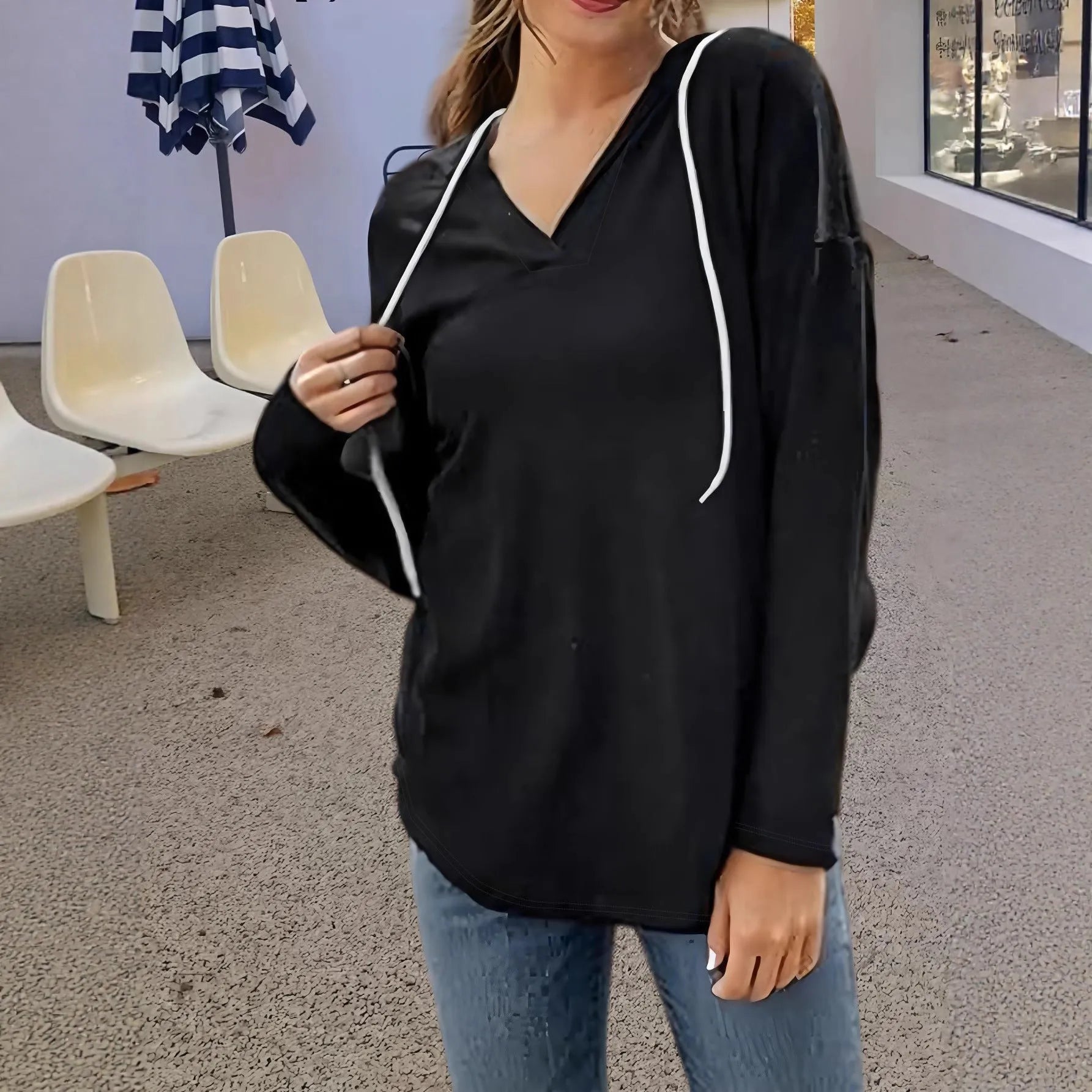 Red women's loose fit hooded V-neck sweatshirt on a hanger