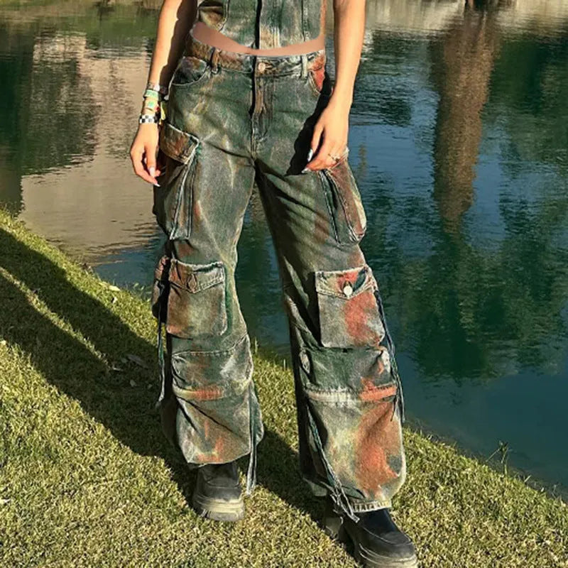 Women's loose cargo denim trousers with a colour bloom wash and gradient colour pockets on a street style background.
