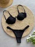 Women's black underwire bikini swimsuit with split high-leg briefs on a mannequin.