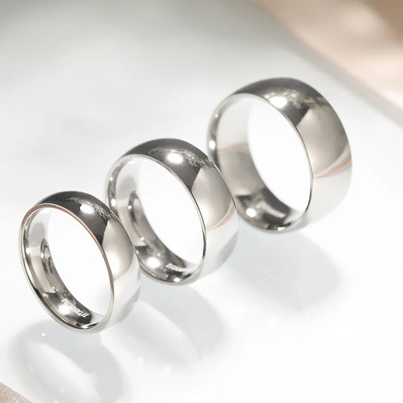 A simple matte silver titanium ring shown in three width options: 2mm, 4mm, and 6mm.