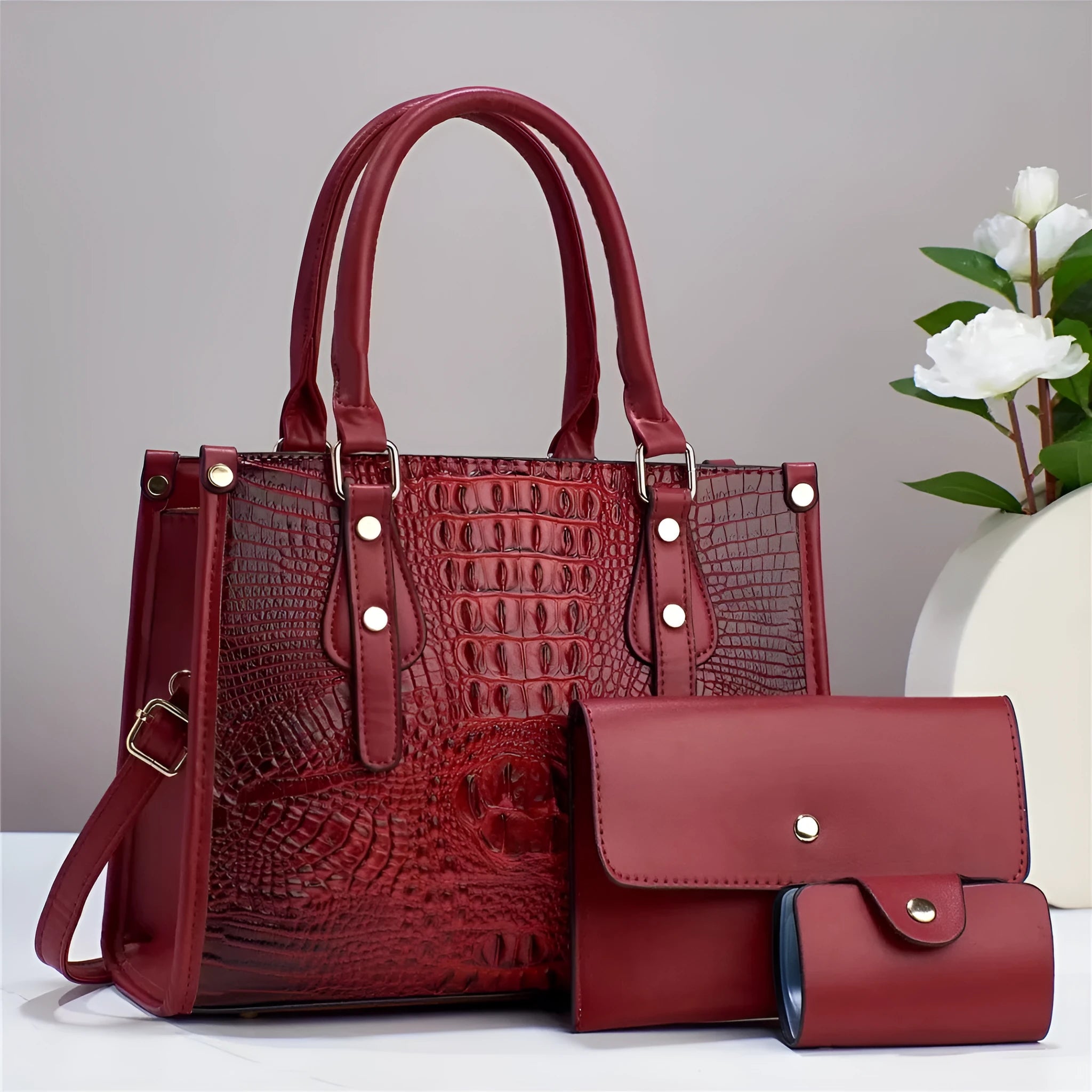 Ladies' burgundy PU leather three-piece bag set showing crossbody bag, wallet and card holder.