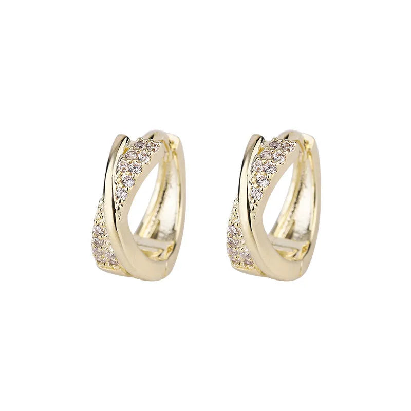 A pair of geometric-shaped copper earrings with a zircon-treated 14K yellow finish.