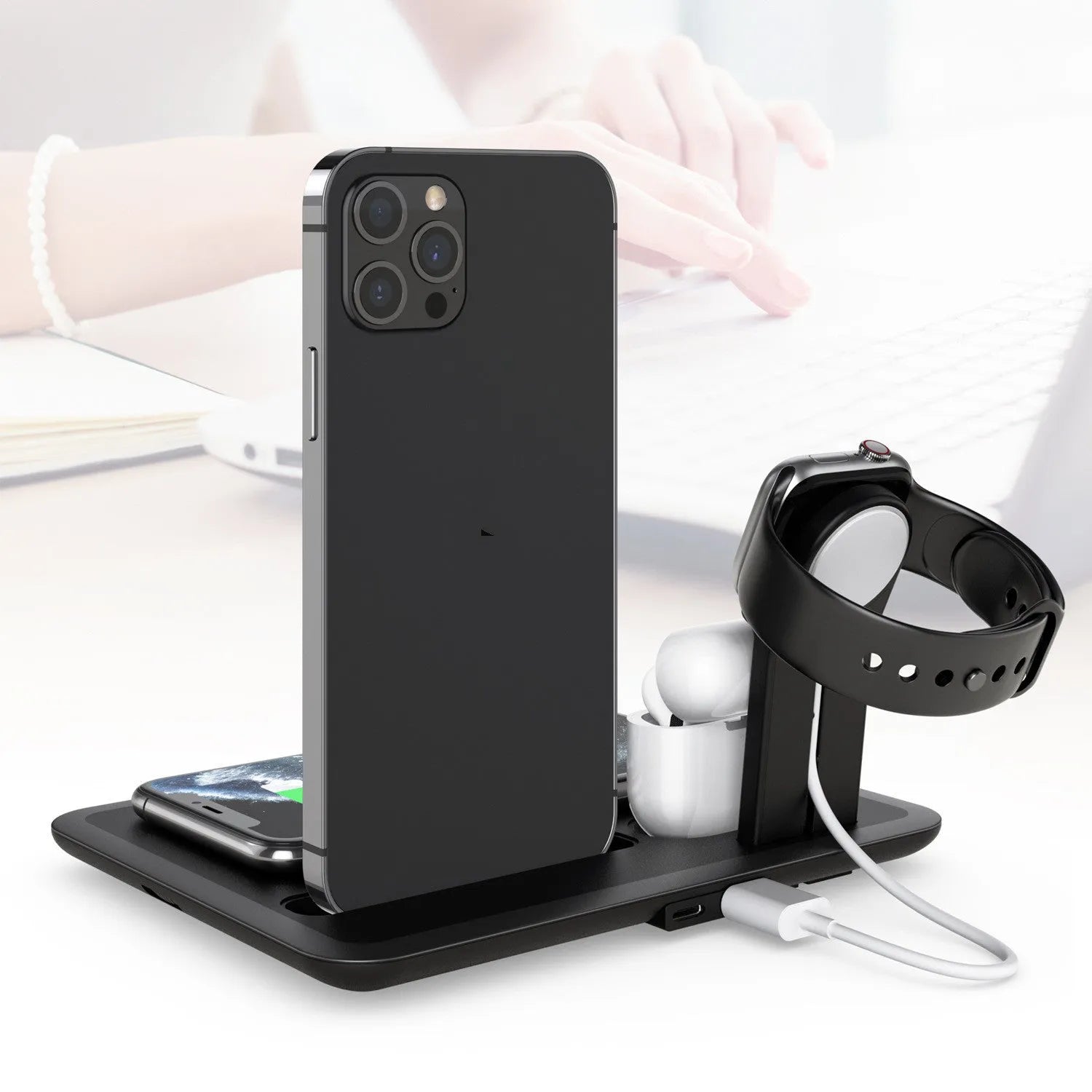Wireless desktop charger with phone bracket showing watch and headphone charging ports in black finish