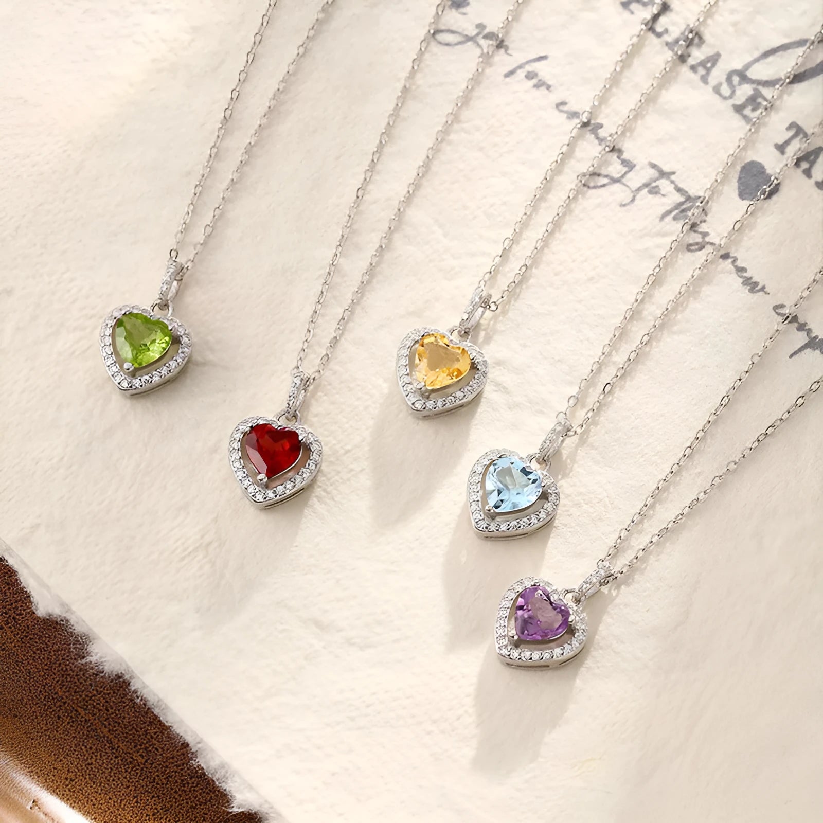 Women's sterling silver heart necklace with a round amethyst gemstone pendant on a cross chain.