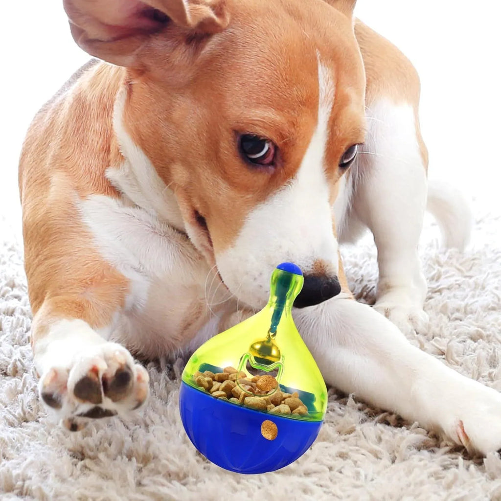 Light grey interactive pet treat dispenser ball with tumbler shape on a wooden floor.