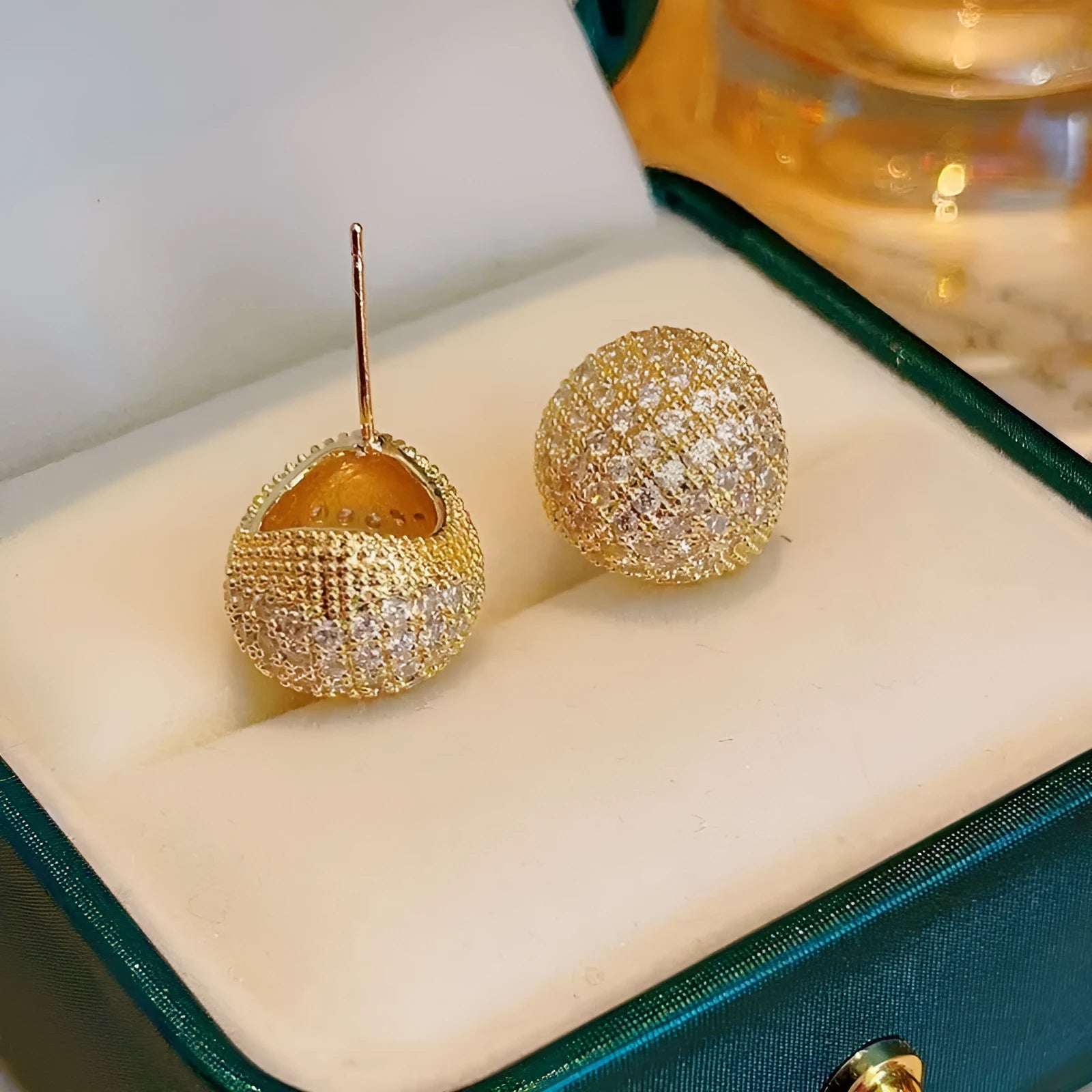 Geometric drop-shaped women's earrings with full diamond detailing and golden bean elements