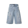 Distressed denim shorts with raw-edge hems in black, shown in a straight-leg cropped fit.