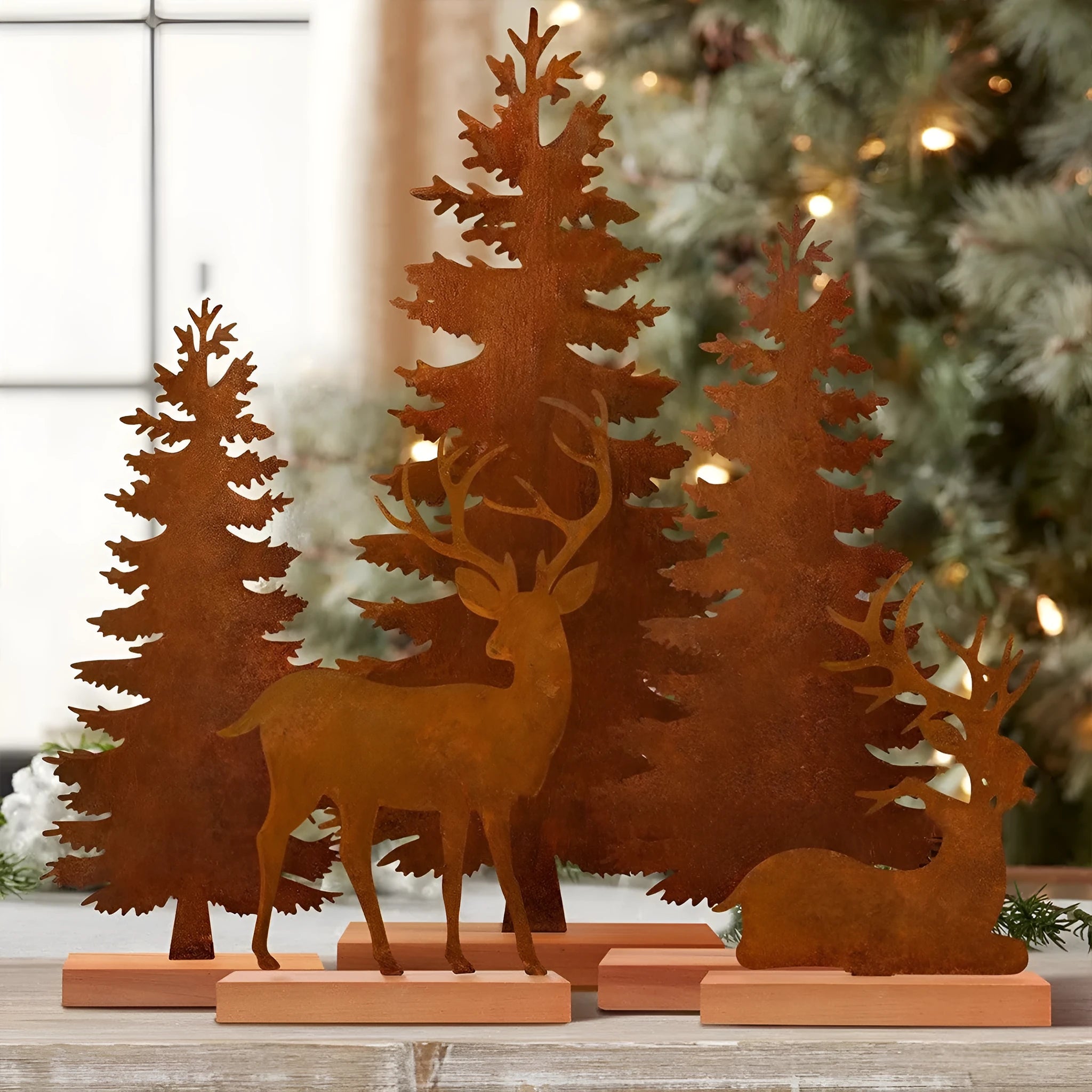 Three metal Christmas tree ornaments with elk silhouettes and rustic rust-effect finish