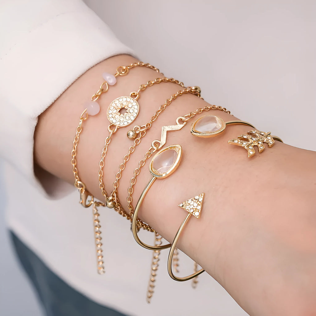 Gold-coloured zinc alloy bracelet set with six charms including arrow, water drop, V, and spot drill designs.