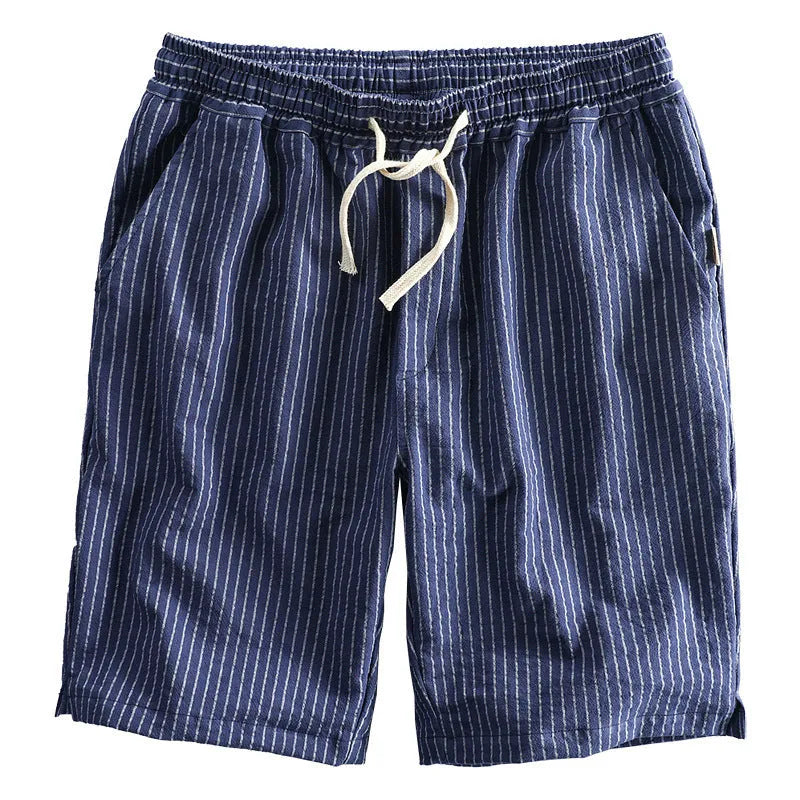 Man wearing loose fit striped cotton shorts in a casual setting.