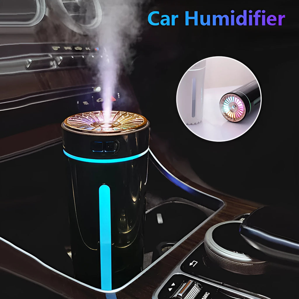 Compact black wireless humidifier with colourful LED lights sitting in car cup holder