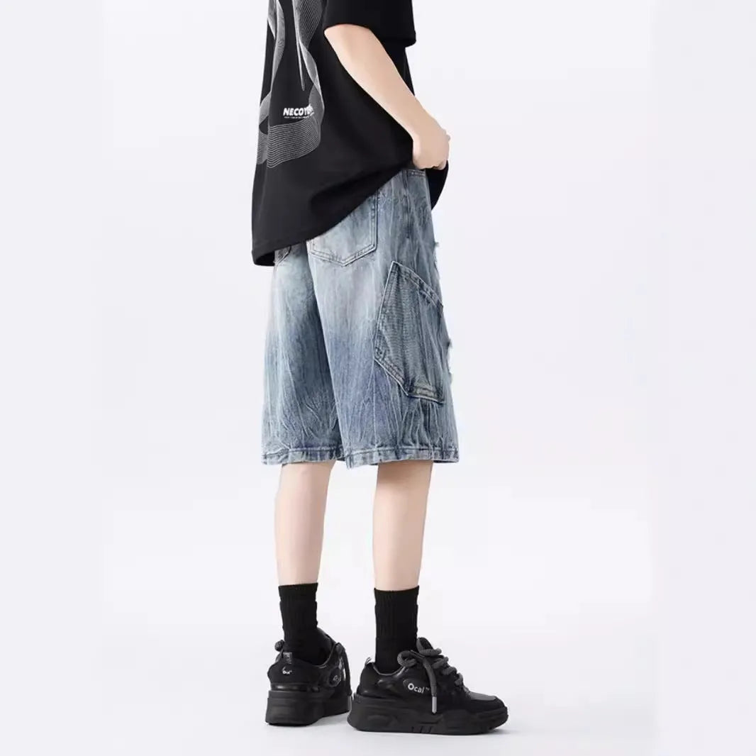 Men's ripped denim shorts with washed finish in black and blue colours showing loose fit design