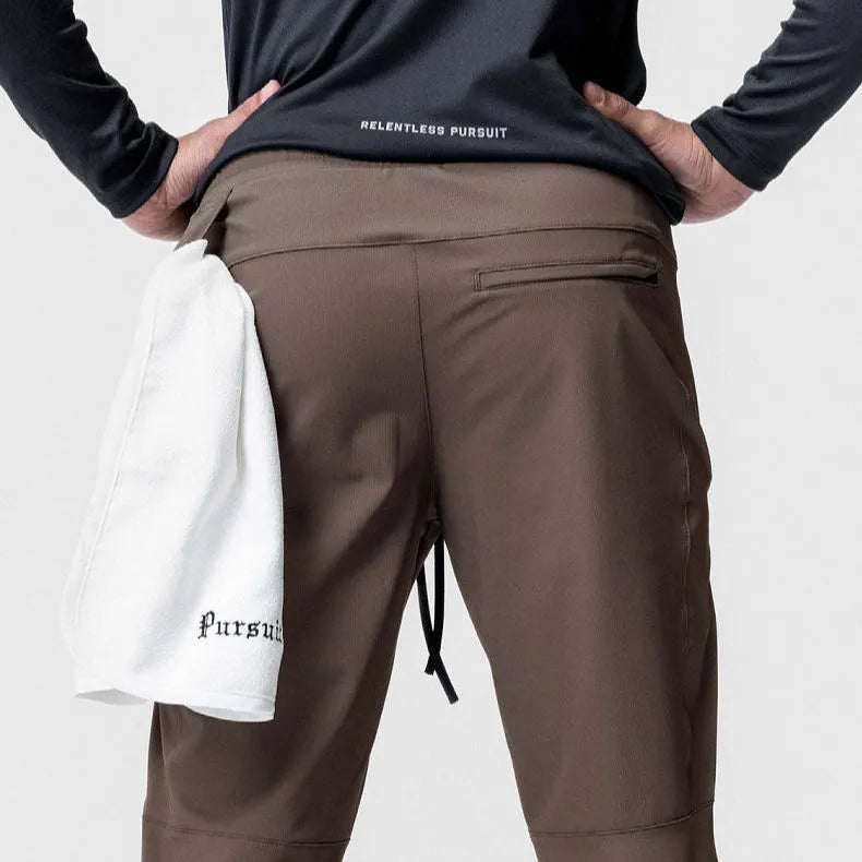 Men's loose-fit ankle-tied trousers in olive green, suitable for fitness and casual wear.