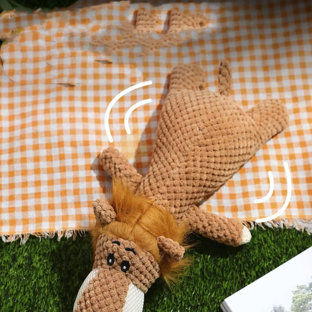Green plush dog chew toy shaped like an animal with a textured corn kernel surface.